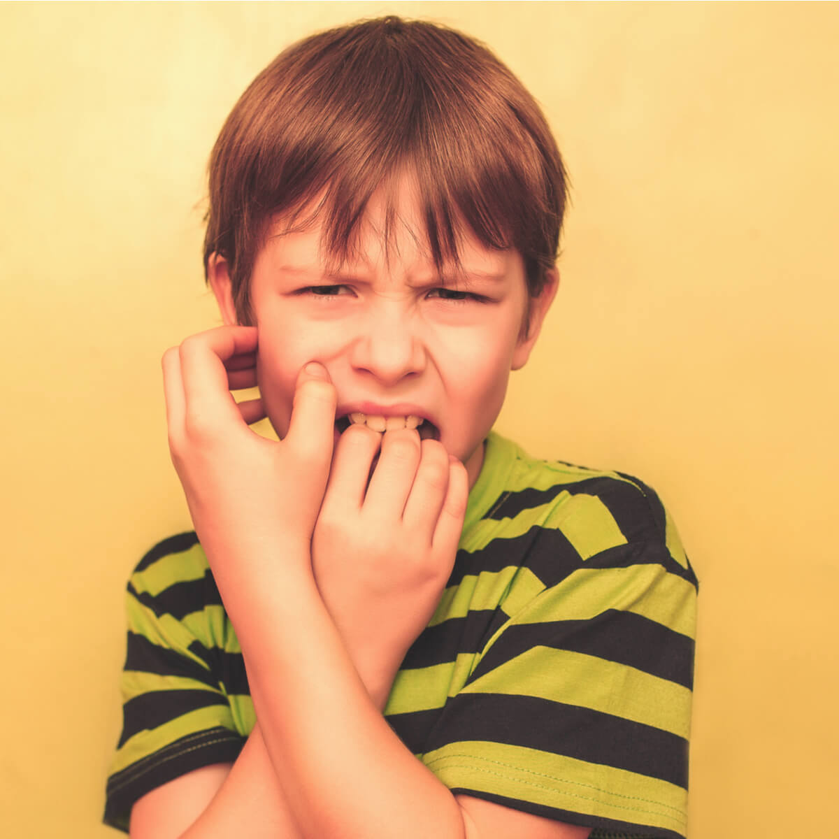 A boy feeling pain in his jaws and in his teeth due to a crossbite.